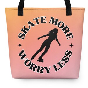 May include: A tote bag with a peach to pink gradient background and black handles. The center features a black circular graphic with the text "SKATE MORE WORRY LESS" surrounding a silhouette of a person on roller skates with small star accents.