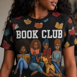May include: Black t-shirt with the text "BOOK CLUB" in white block letters. The shirt features an illustration of four women reading books, with open books scattered across the top. The women are depicted with different hairstyles and clothing.