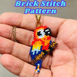 May include: A colorful beaded parrot pendant necklace. The parrot is crafted with red, orange, yellow, blue, and black beads. The necklace has a gold-colored chain and the text "Brick Stitch Pattern" in blue.