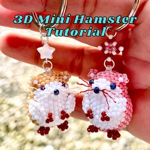 May include: Two 3D mini hamster keychains crafted from small beads. One hamster is tan and white with a star charm, the other is pink and white with a flower charm. Both have dark eyes and red bead feet. Text reads: 3D Mini Hamster Tutorial.