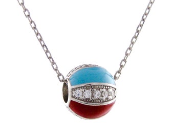 May include: A silver chain necklace with a round pendant. The pendant is red, blue, and white with clear rhinestones.