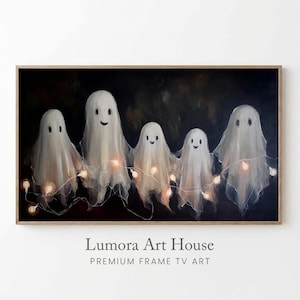 May include: A rectangular digital art print for a television screen featuring five white ghost figures against a dark background. The ghosts are connected by a string of glowing warm-toned fairy lights. The text Lumora Art House Premium Frame TV Art is visible below the image.