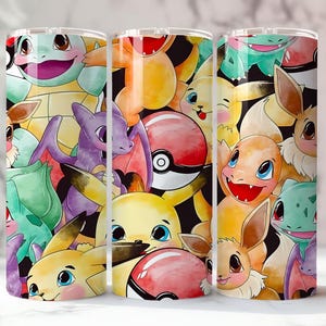 May include: A set of three stainless steel tumblers featuring a colorful collage of various cartoon characters. The design includes images of Pikachu, Charmander, Squirtle, and other characters on a black background.