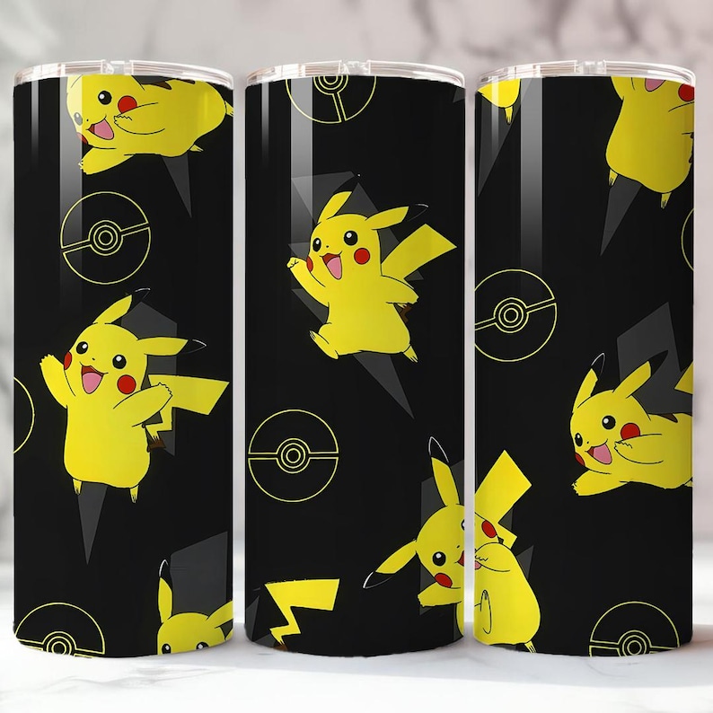 May include: A black tumbler featuring a repeating pattern of yellow Pikachu characters, lightning bolts, and Pok&eacute; Ball designs. The tumbler has a silver lid and is designed for cold beverages.