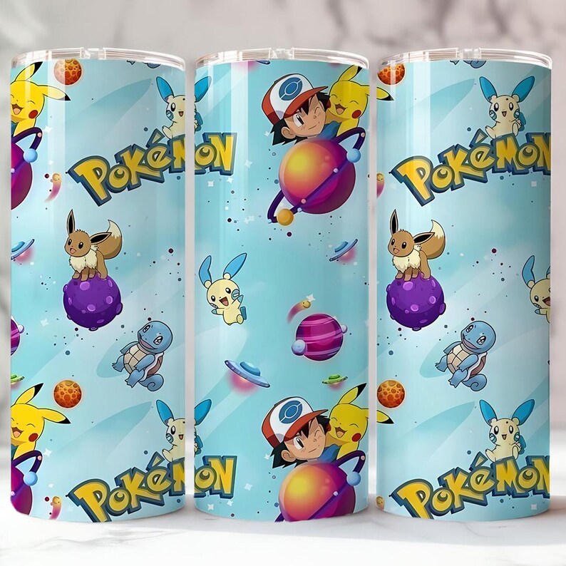 May include: Three stainless steel tumblers with a light blue background featuring various Pok&eacute;mon characters, planets, and the Pok&eacute;mon logo. The design includes Pikachu, Eevee, and Ash Ketchum. The tumblers are designed for cold beverages.