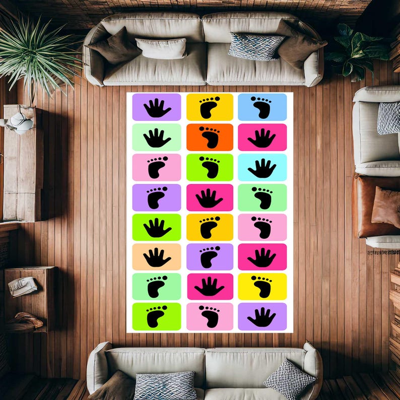 May include: A rectangular floor mat featuring a grid of colourful rectangles, each containing a black silhouette of either a handprint or a footprint. The background colours include shades of purple, yellow, blue, green, pink, and orange.