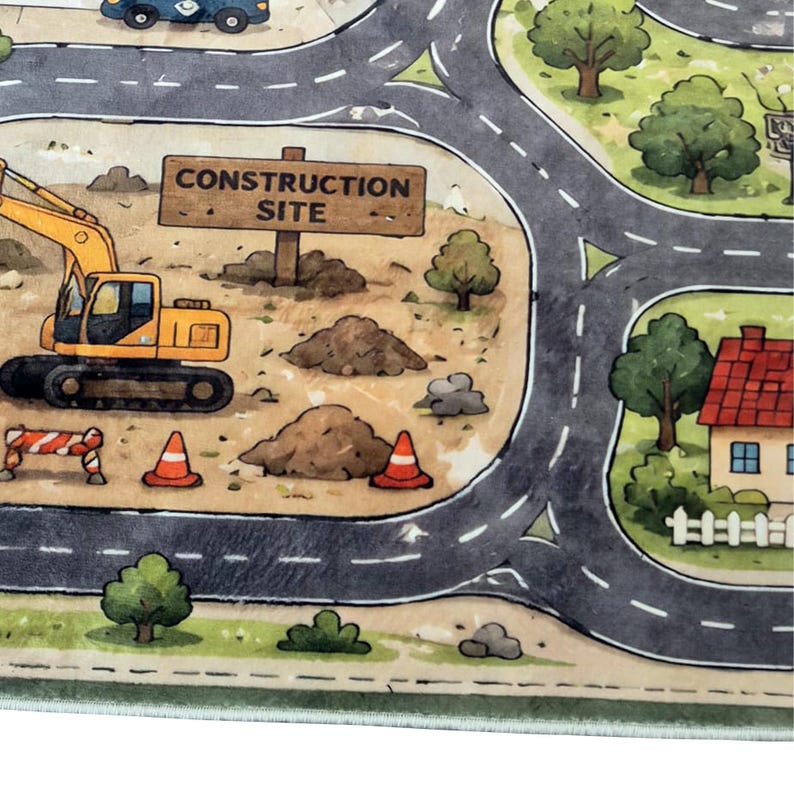 May include: A play rug featuring a printed road network, a yellow excavator, piles of dirt, orange traffic cones, and a wooden sign labeled CONSTRUCTION SITE. The design includes green trees and a house with a red roof and white fence.
