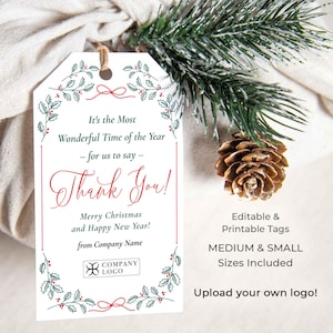 May include: A white gift tag with a festive design, featuring the text "Thank You!" in red script, surrounded by green and red botanical illustrations. The tag includes the text "Merry Christmas and Happy New Year!" and space for a company logo.