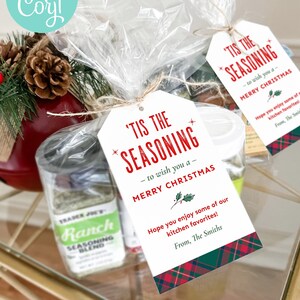 May include: Printable gift tags with a red and green plaid design. The tags feature the text "'Tis the Seasoning - to wish you a Merry Christmas." and a message about enjoying kitchen favorites. The tags are 2.5 inches wide and 4.25 inches tall.