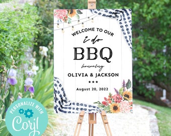 May include: A white wooden sign with a black and white checkered pattern on the top and bottom. The sign says "Welcome to our i do BBQ honoring Olivia & Jackson August 20, 2022". The sign is decorated with watercolor flowers and string lights.