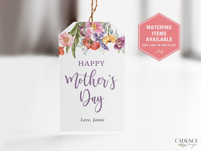 May include: A white gift tag with a watercolor floral design in shades of pink, purple, yellow, and orange. The tag reads "Happy Mother's Day" in purple script and "Love, Jamie" in black text.