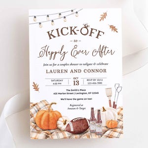 May include: A white invitation card featuring brown text that reads KICK-OFF to Happily Ever After, Lauren and Connor, and event details. The design includes watercolor illustrations of string lights, autumn leaves, a football, pumpkins, and bottles.
