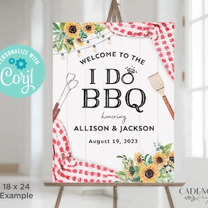 May include: A welcome sign for a barbecue party with the text "I DO BBQ" in black lettering on a white wooden background. The sign is decorated with sunflowers, string lights, and a red and white checkered tablecloth. The text "honoring Allison & Jackson" and "August 19, 2023" is also included.