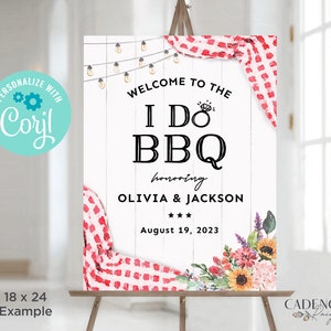 May include: A white wooden sign with red and white checkered fabric and floral accents. The sign says "Welcome to the I Do BBQ honoring Olivia & Jackson August 19, 2023".