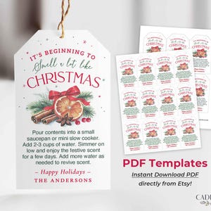 May include: White Christmas gift tags with the text "It's Beginning to Smell a lot like Christmas." The tags feature a festive design with a red bow, cinnamon sticks, and an orange slice. Instructions are included. PDF templates are available.
