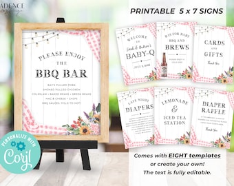 May include: Printable 5x7 signs for a baby shower with a BBQ theme. The signs feature a pink and white gingham pattern with floral accents. The text on the signs includes "Please Enjoy the BBQ Bar", "Welcome to Sarah & Andrew's Baby-Q", "Bis for Baby BBQ and Brews", "Late Night Diapers", "Lemonade & Iced Tea Station", "Cards and Gifts", and "Diaper Raffle".