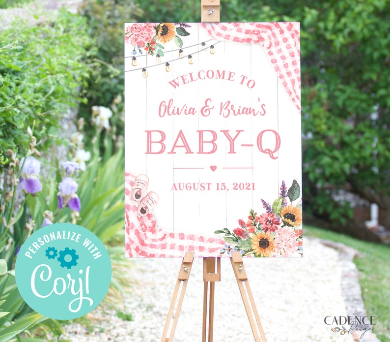 May include: A pink and white welcome sign with a gingham pattern and floral accents. The sign reads "Welcome to Olivia & Brian's Baby-Q August 15, 2021".