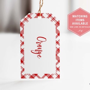 May include: Red and white plaid gift tag with the word "Orange" written in red cursive.