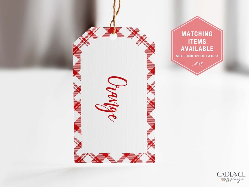 May include: Red and white plaid gift tag with the word "Orange" written in red cursive.
