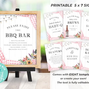 May include: Printable 5x7 signs for a baby shower with a BBQ theme. The signs feature a pink and white gingham pattern with floral accents. The text on the signs includes "Please Enjoy the BBQ Bar", "Welcome to Sarah & Andrew's Baby-Q", "Bis for Baby BBQ and Brews", "Late Night Diapers", "Lemonade & Iced Tea Station", "Cards and Gifts", and "Diaper Raffle".