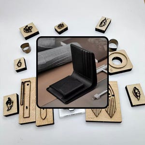 May include: A black leather wallet with multiple card slots is displayed open, showcasing its interior. Surrounding the wallet are various wooden craft tools and metal rings, suggesting leather crafting. The tools include stamps and cutting dies.