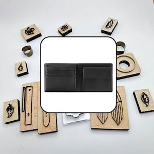 May include: A black leather bifold wallet featuring multiple horizontal card slots on the left side and a single flap-covered coin pocket on the right side, surrounded by various wooden and metal leathercraft cutting dies on a white surface.