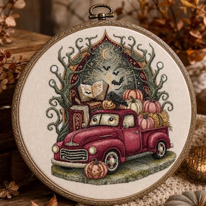 May include: A circular embroidery hoop containing a cross-stitch design of a red vintage pickup truck loaded with pumpkins and hay. The scene features a black crow, an open book, a crescent moon, bats, and twisted tree branches in the background.