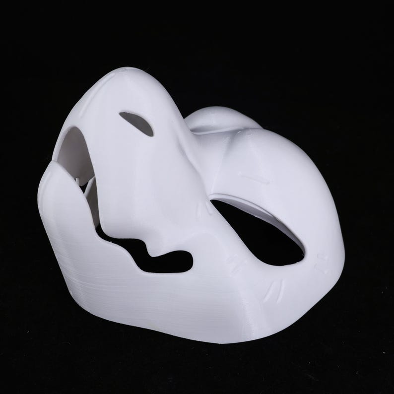May include: A white mask with a smooth finish, featuring large eye openings and a curved snout. The mask is designed to cover the face and is likely intended for costume or cosplay purposes. The mask is made of a solid material.