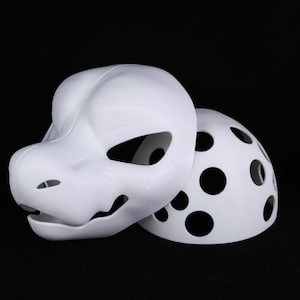 May include: A white, unpainted fursuit head and back piece. The head features a stylized animal design with large eye openings and a detailed snout. The back piece has multiple circular cutouts. The items are set against a black background.