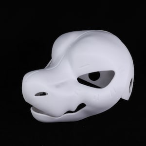 May include: A white dragon-style mask with large eye openings and a detailed snout. The mask has a smooth surface and is designed to be worn. The mask is made of a lightweight material.