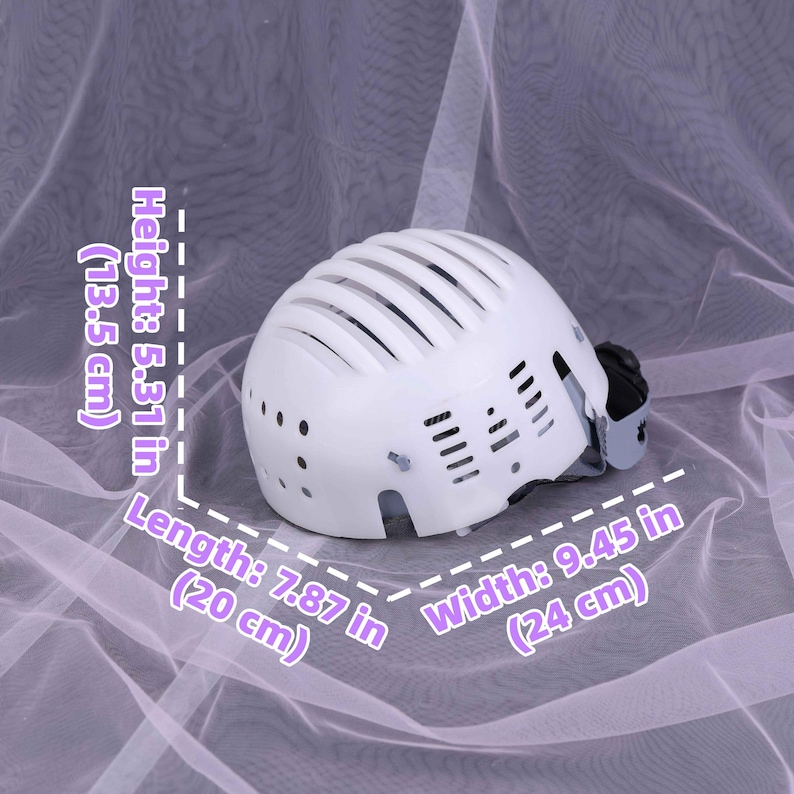 May include: White helmet with a vented design. The helmet is 5.31 inches (13.5 cm) high, 7.87 inches (20 cm) long, and 9.45 inches (24 cm) wide. It features a chin strap and a black adjustment mechanism.