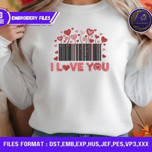 May include: White sweatshirt featuring a Valentine's Day design. The design includes a barcode with red hearts and the words "I LOVE YOU" in a pink font. The image also includes the text "EMBROIDERY FILES".