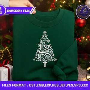 May include: A dark green sweatshirt featuring a white Christmas tree design with the word "JESUS" and a cross. The image includes text that says "EMBROIDERY FILES" and "FILES FORMAT : DST, EMB, EXP, HUS, JEF, PES, VP3,XXX".