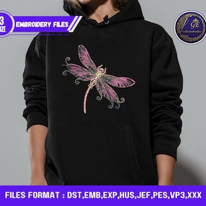 May include: Black hoodie featuring a pink and yellow dragonfly embroidery design. The dragonfly has detailed wings and a slender body. The hoodie also has the text "EMBROIDERY FILES" and "3 SIZE".