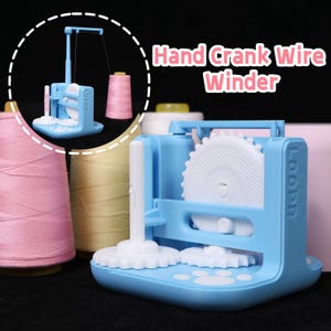May include: A light blue hand crank wire winder with white gears and the word "LOOPR" printed on the side. The winder is designed to hold thread spools. The text "Hand Crank Wire Winder" is in the upper right corner.