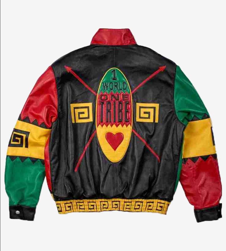 May include: Black leather jacket with red, yellow, and green detailing. The back displays the words "1 World One Tribe" and a heart-shaped emblem. The sleeves have geometric patterns and the jacket has a ribbed hem.