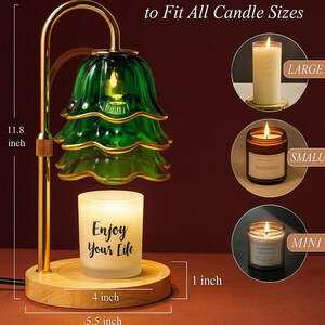 May include: A candle warmer with a green glass shade and a gold-colored metal frame. The base is made of wood and holds a candle that reads "Enjoy Your Life". The warmer is 11.8 inches tall and designed to fit all candle sizes.