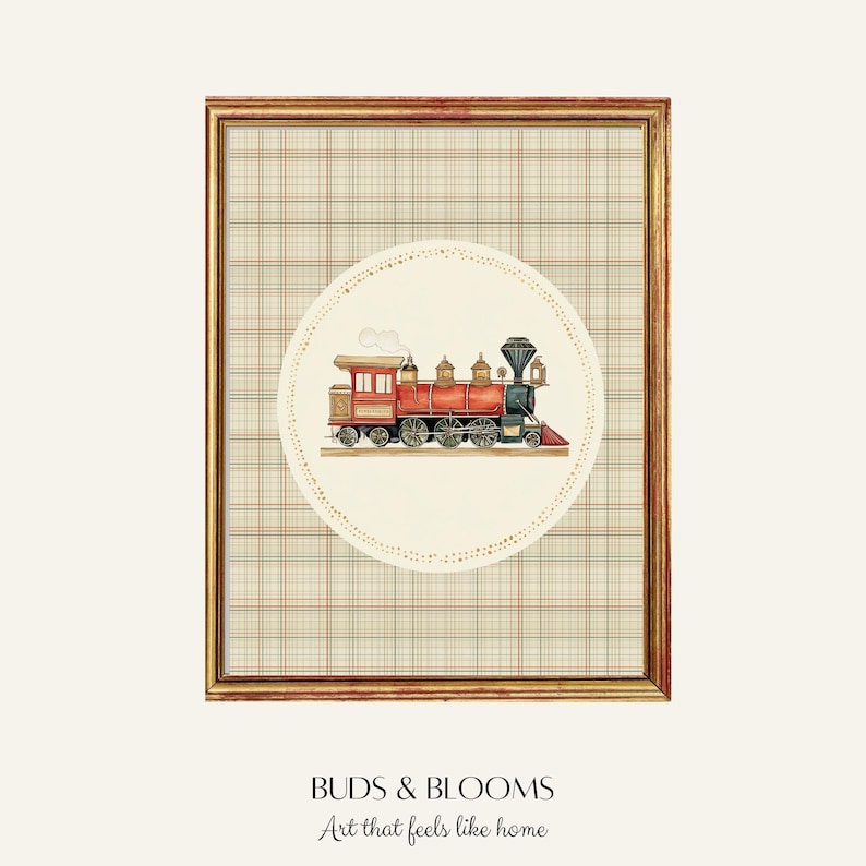 May include: Framed artwork featuring a watercolor illustration of a vintage red and gold train. The train is set against a cream-colored circle with a dotted border, placed over a plaid background. The frame is gold. The text "BUDS & BLOOMS Art that feels like home" is at the bottom.