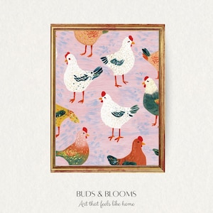 Könnte beinhalten: Ein gerahmter Kunstdruck mit einem sich wiederholenden Muster aus bunten Hühnern auf rosa Hintergrund. Die Hühner haben rote Kämme und detaillierte Federn. Der goldene Rahmen umgibt das Kunstwerk, mit dem Text "BUDS & BLOOMS Art that feels like home" unten.