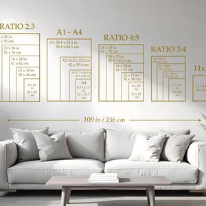 May include: A wall display featuring various rectangular frames with dimensions in inches and centimeters, labeled with ratios like 2:3, 4:5, and 3:4. The text includes measurements such as 24 x 36 in (61 x 91 cm). A sofa and table are in the foreground.