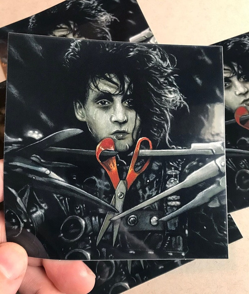 May include: A black and white illustration of a man with long black hair, wearing a black leather jacket with a red pair of scissors in his mouth. The background is dark and there are several other scissors in the image.