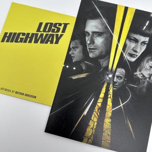 May include: A yellow card with the words "LOST HIGHWAY" in black text, and a black and white illustration of a movie poster. The artwork is by Nathan Anderson. The poster features several faces and a road.