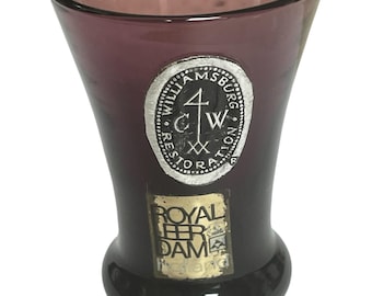 Amber shot glass with Williamsburg and Royal Dam labels