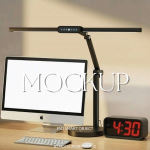 May include: A black desk lamp with a long, rectangular light head and a control panel. A computer monitor with the word "MOCKUP" on the screen, a keyboard, and a digital clock displaying 4:30 are also visible.