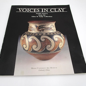 May include: A book cover featuring a Pueblo pottery design. The title "VOICES IN CLAY" is at the top, with details about the Edna M. Kelly Collection. The pottery is brown, cream, and black, with intricate patterns. The Miami University Art Museum is also noted.