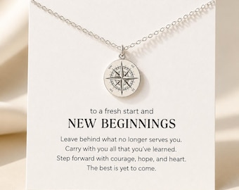 May include: A silver-toned necklace featuring a circular pendant with an engraved compass rose design. The pendant is attached to a delicate chain and displayed on a white card printed with the text: to a fresh start and NEW BEGINNINGS. Leave behind what no longer serves you. Carry with you all that you've learned. Step forward with courage, hope, and heart. The best is yet to come.