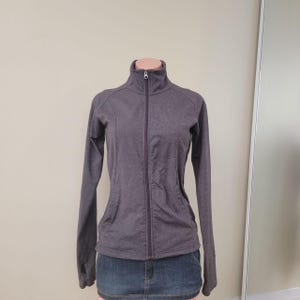 Chaqueta deportiva ajustada con cremallera y color gris jaspeado de Tuff Performance (Talla S)