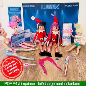 May include: A display featuring dolls, elf figures in red outfits, and accessories. The backdrop reads "LUTRX WORLD TOUR". Various signs with text are also present, all arranged on a wooden surface.