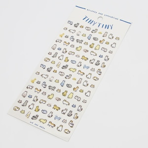 May include: A sheet of stickers featuring numerous cartoon cats in various poses and colors, including yellow, gray, and blue. The stickers are on a white background with the text "TINY TINY" and "RELAXED AND COMFORTING".