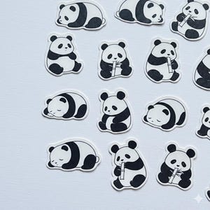 May include: A collection of individual die-cut stickers featuring black and white illustrations of giant pandas in various poses. Some pandas are depicted sitting upright while eating bamboo stalks, while others are shown lying down and sleeping.
